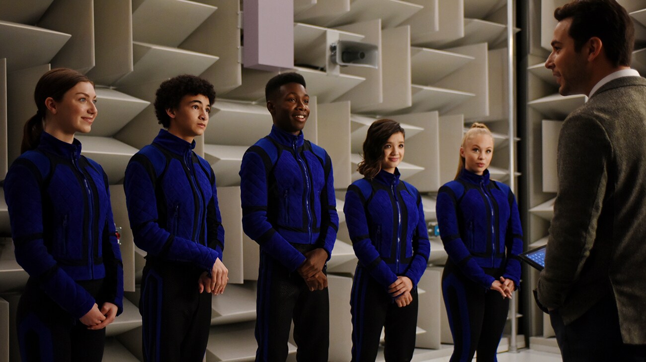 The cast of Secret Society of Second Born Royals in their blue uniforms