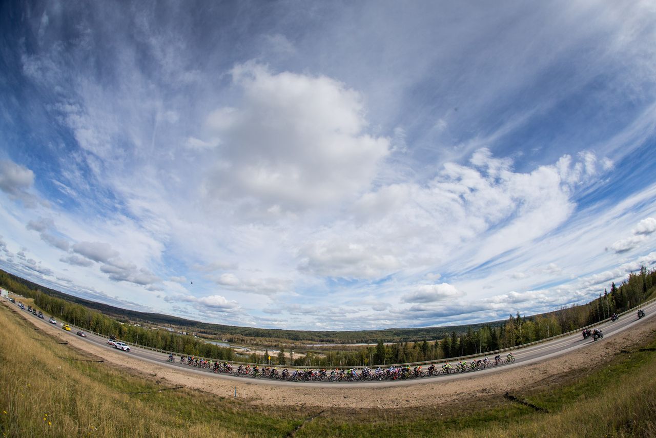 The peloton tackles stage 3's final climb under cloudy skies in Alberta