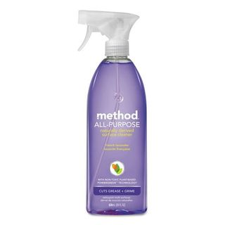 A clear plastic spray bottle with purple liquid inside. A white spray nozzle. Method branding on the front. 