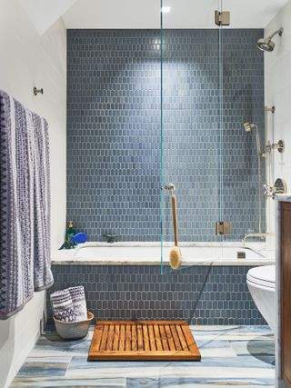 Blue bathroom with blue tiled wall and bath