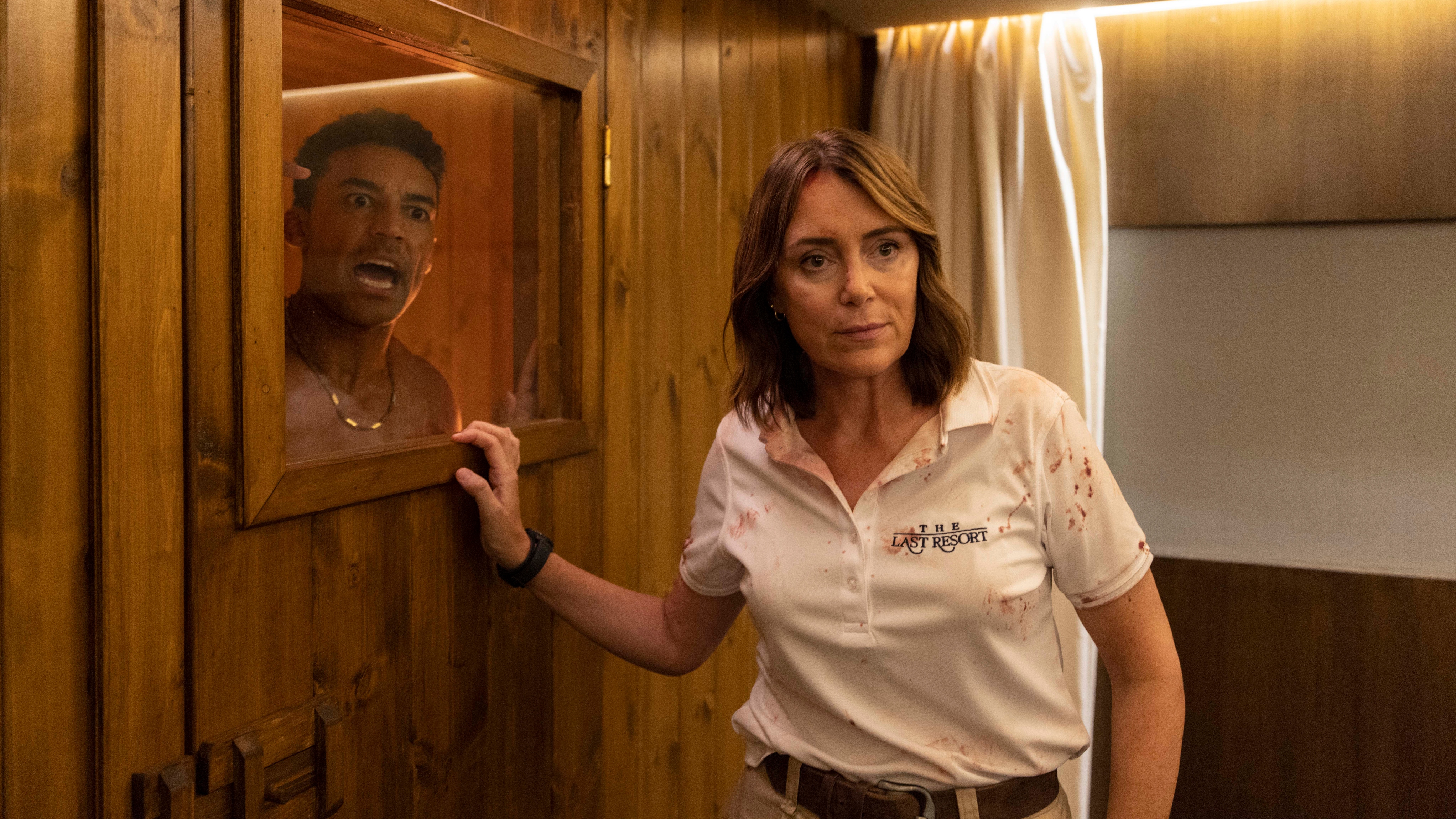 Julie stands by the locked door of a sauna with Ezra yelling from inside in The Assassin