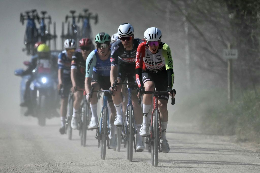 The pack of riders cycle in a breakaway during the 19th one-day classic Strade Bianche (White Roads) men's cycling race between Siena and Siena in Tuscany on March 8, 2025. (Photo by Marco BERTORELLO / AFP)