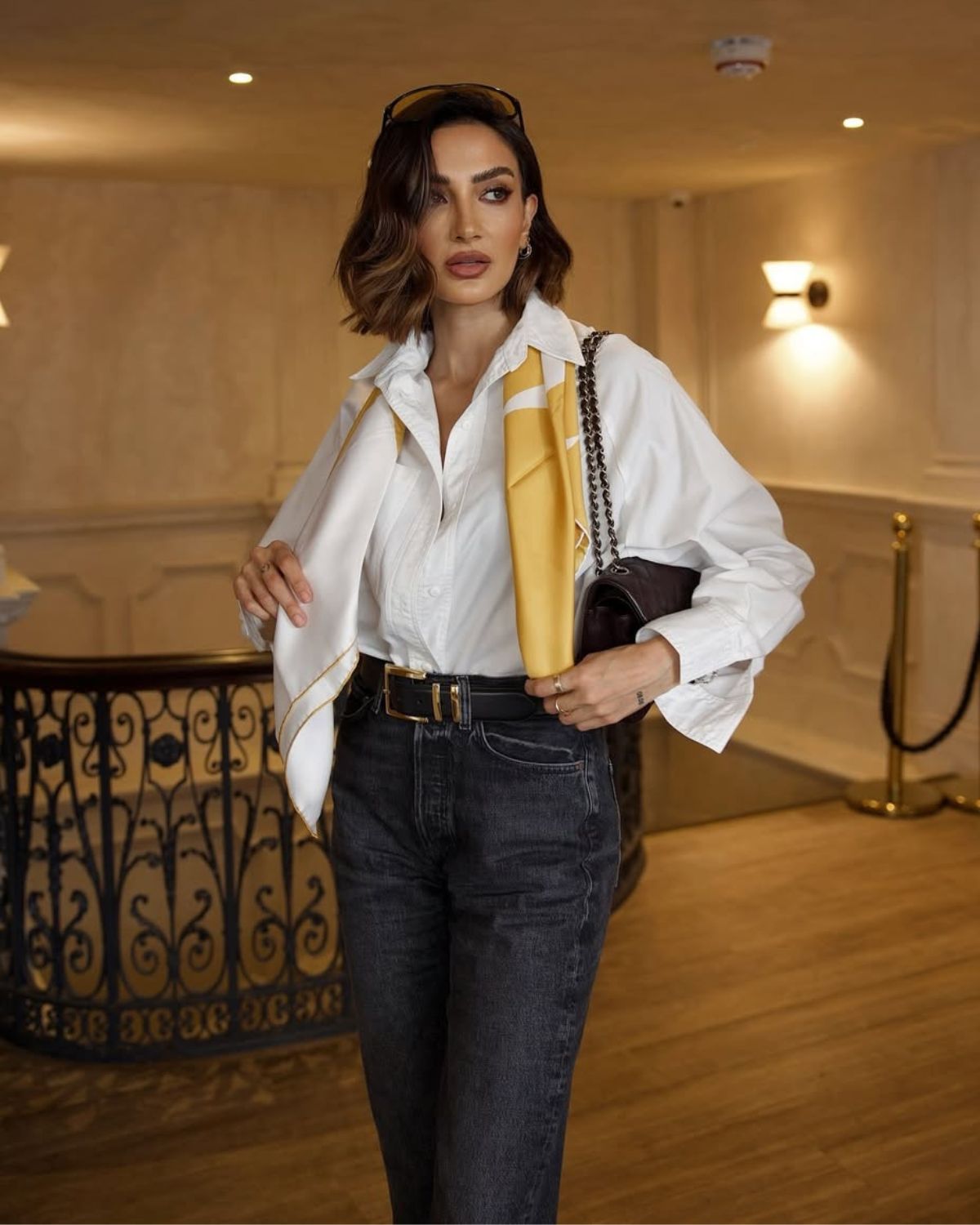@selinergulofficial wears her hair in a caramel highlighted Monaco Bob while wearing a white shirt and jeans