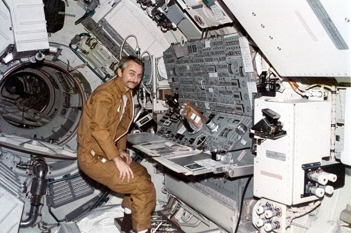 Skylab 3 science pilot Owen Garriott is seen stationed at the Apollo Telescope Mount console aboard the Skylab space station.