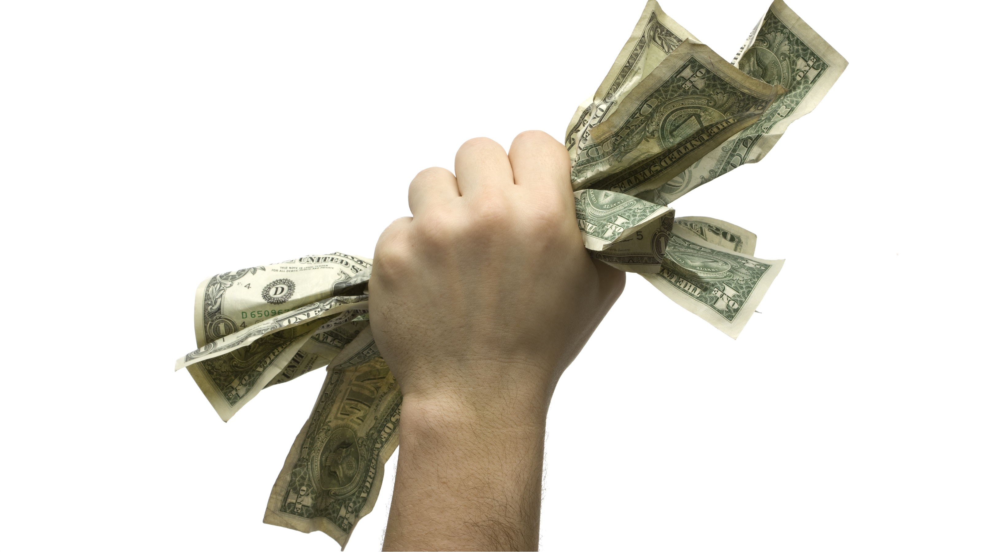 A man's fist holds several dollar bills.