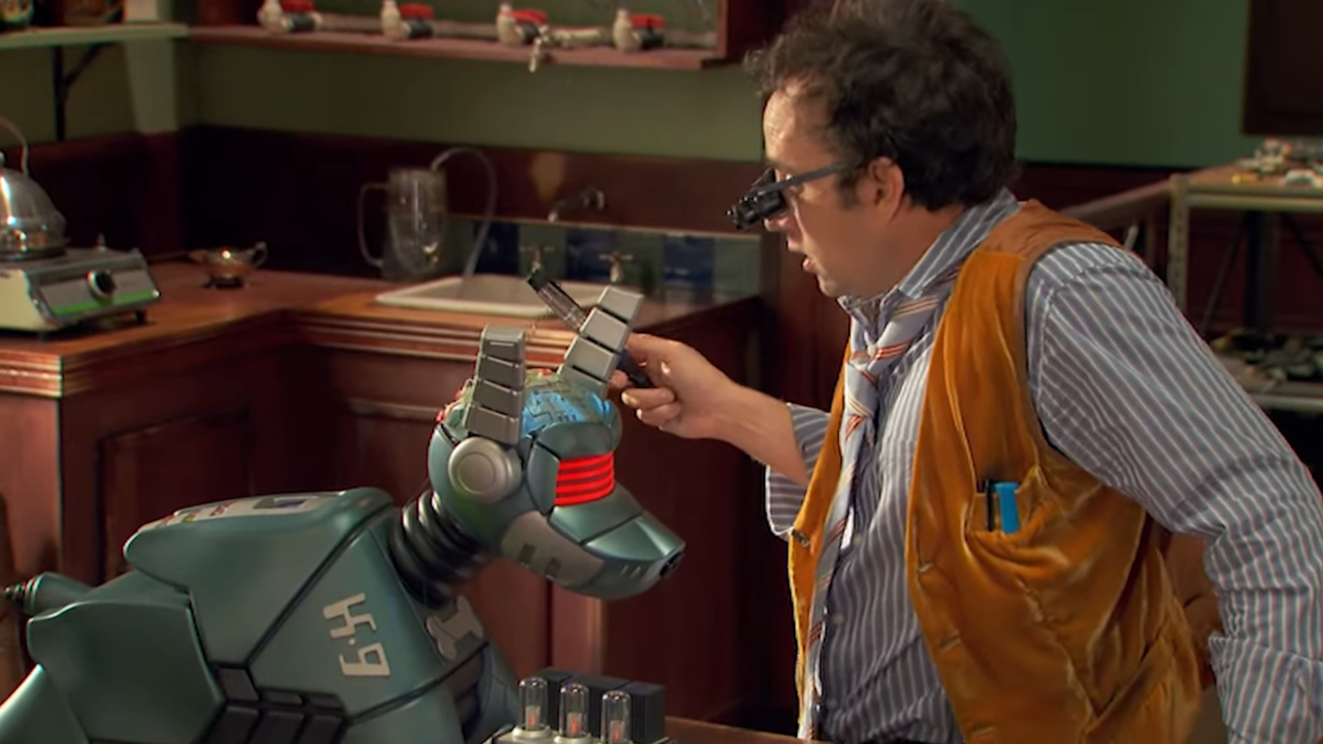 Screenshot showing the robot dog K-9 and a human male attempting to repair him.
