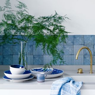 tiles splashback behind a kitchen sink with plates in front of it