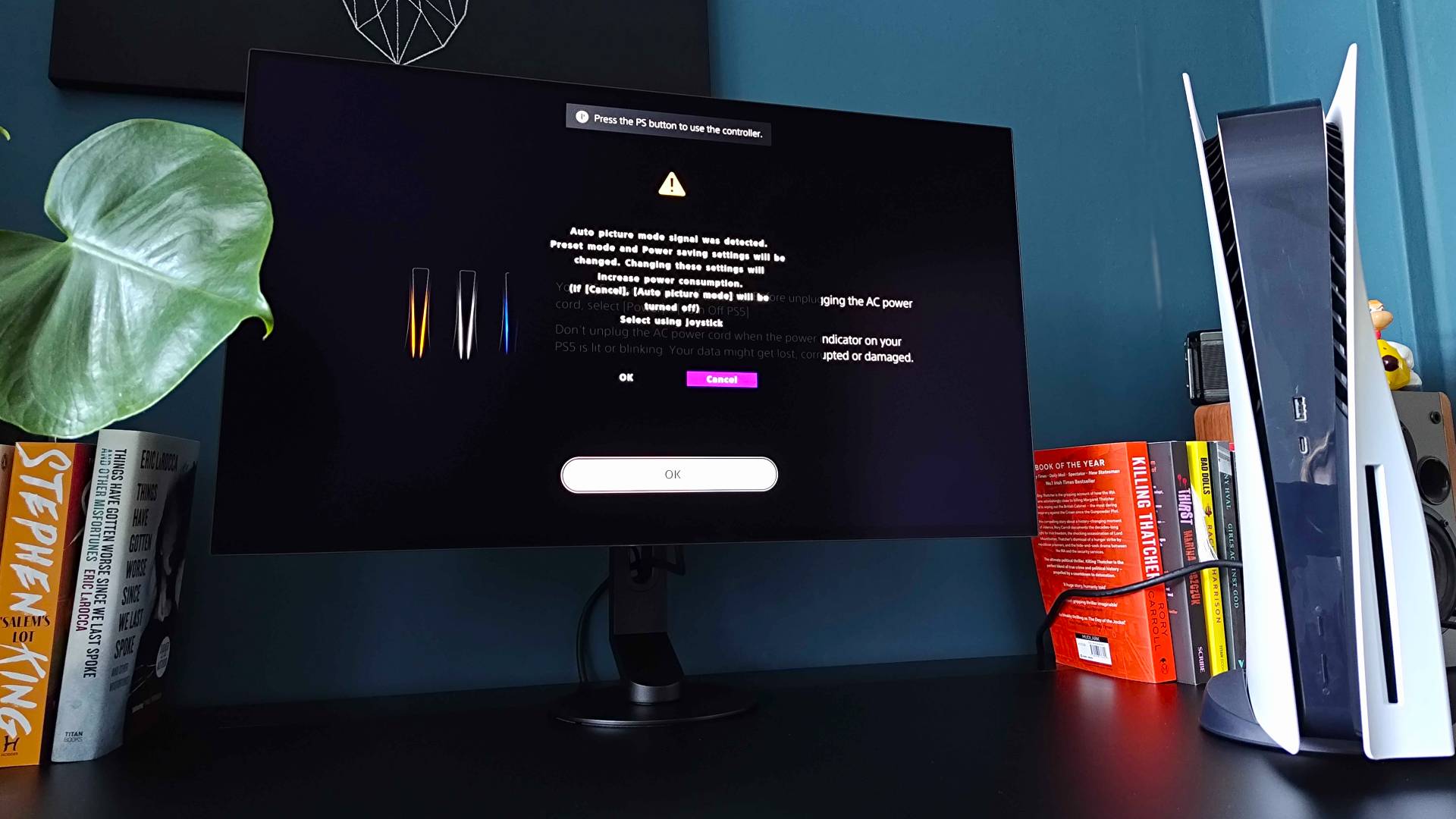 Sony Inzone M10S II next to PS5 with boot-up screen on display and message saying monitor has detected an auto picture mode device.