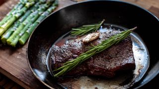 Medium rare steak with asparagus In carbon steel pan