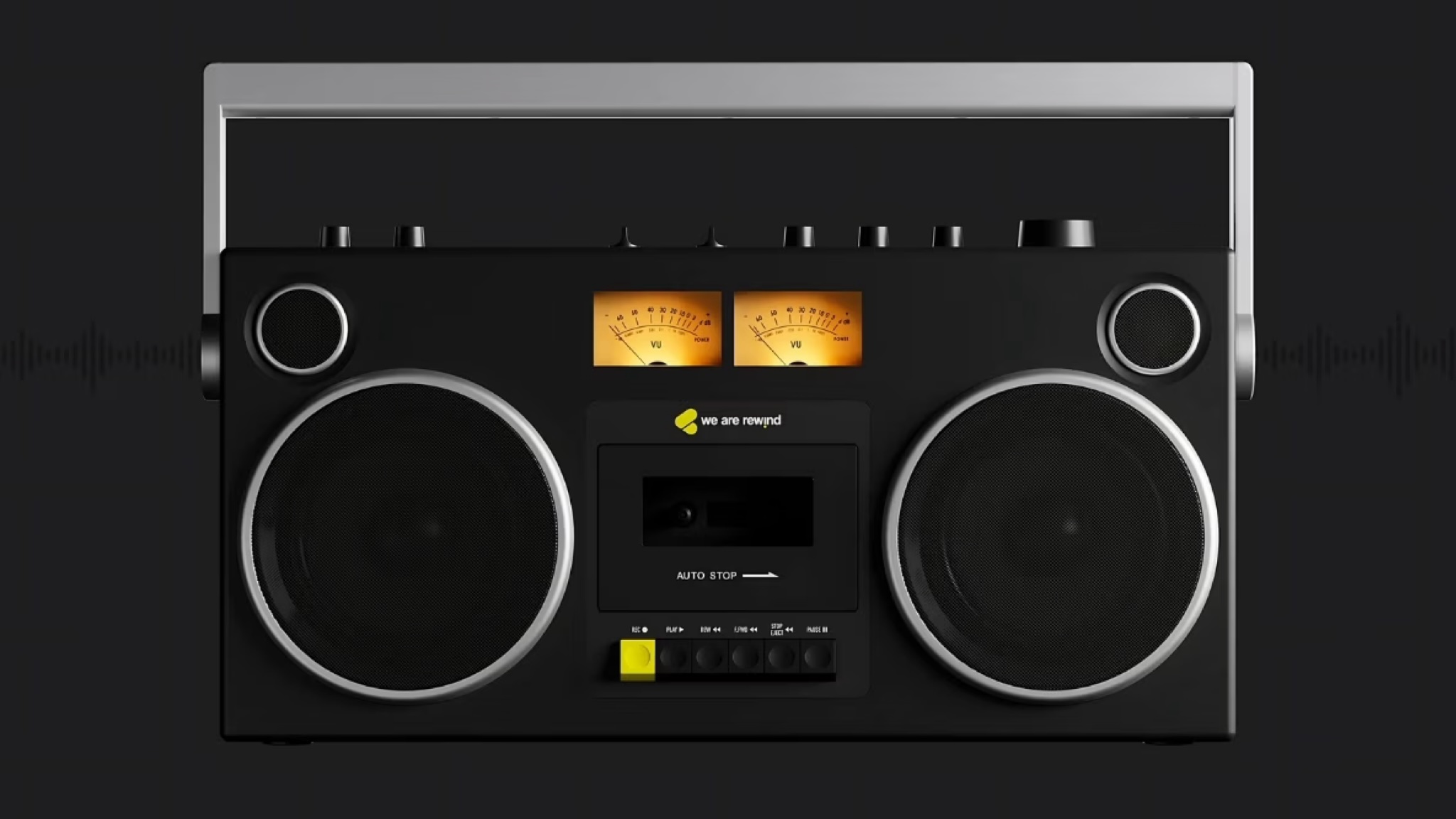 The We Are Rewind GB-001 boom box on a black background. It is black with silver detailing and two VU meters above and between the speaker grilles.