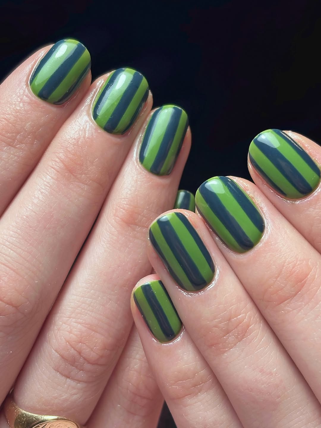 Green and navy striped nails.