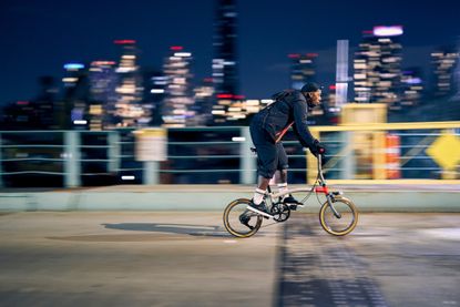 Image shows cyclist riding the Brompton CHPT3 v4 folding bike in New York City