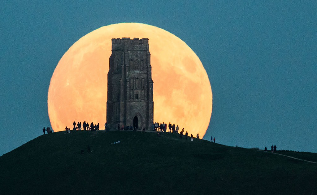 On Sept. 27, 2015, the supermoon rises behind Glastonbury Tor in Glastonbury, England.