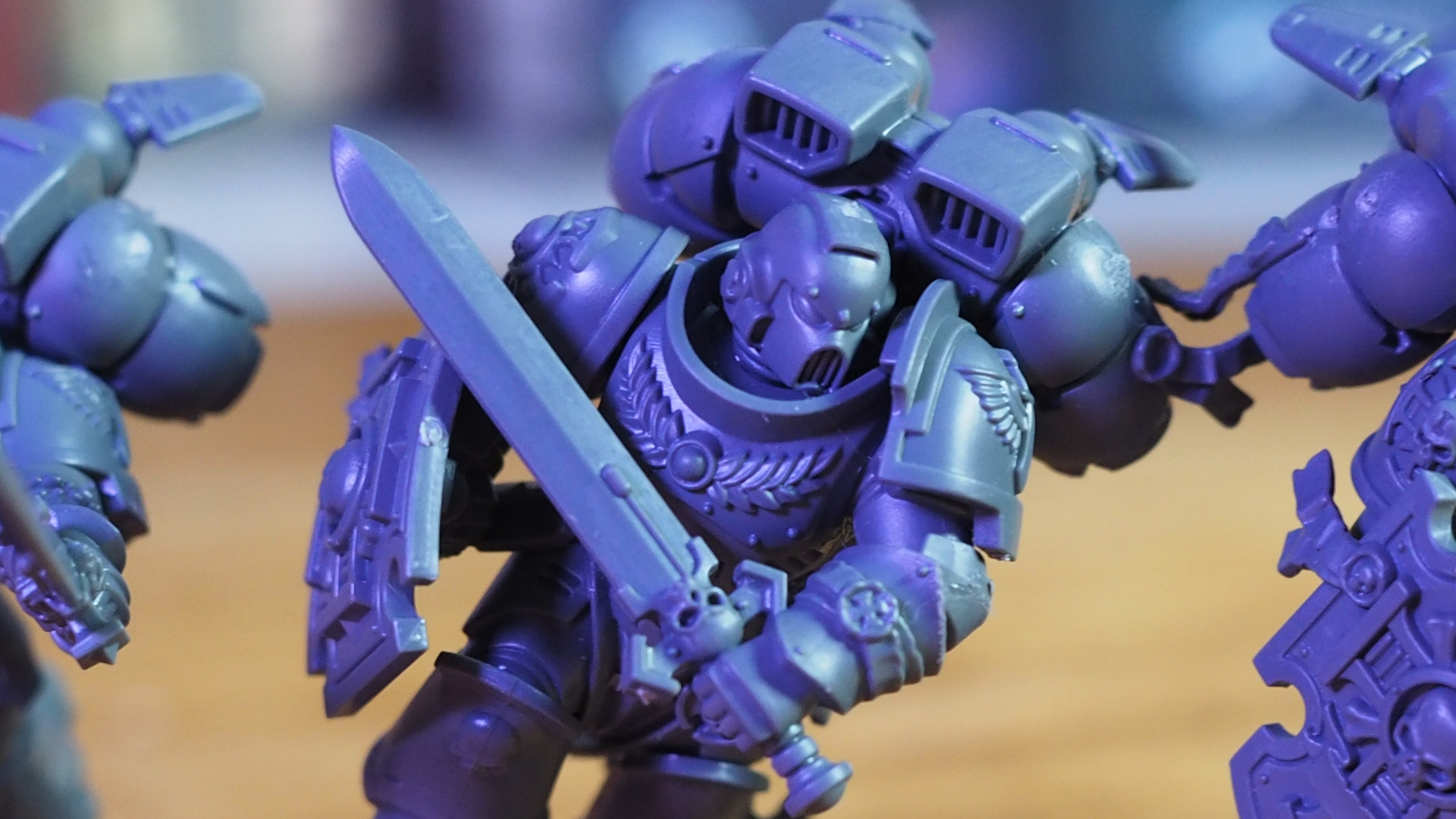 A Vanguard Veteran with a jump pack using a sword charges into battle