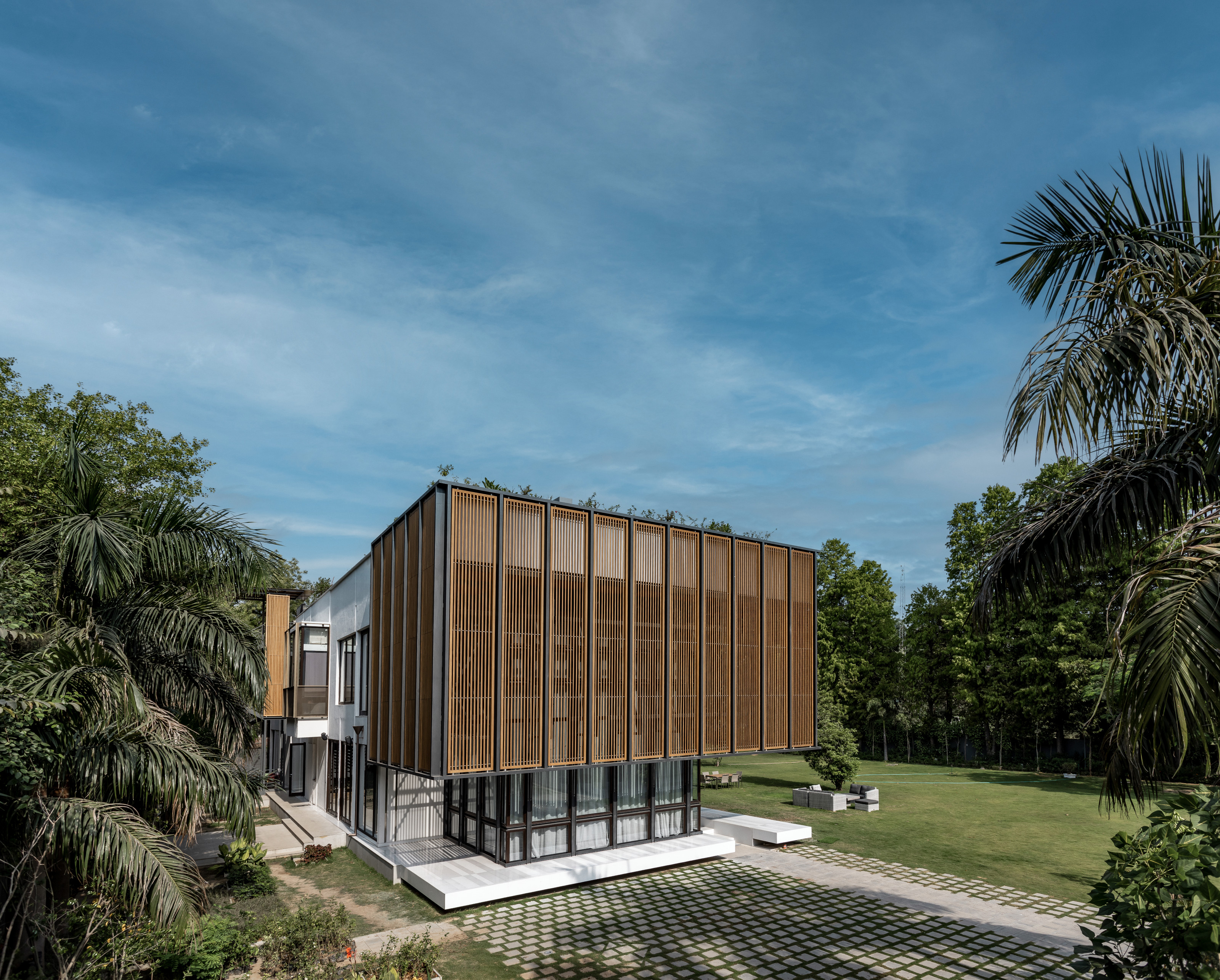 A timber screen envelops the double-height living space at the Lighthouse