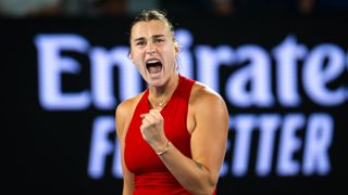 Aryna Sabalenka, wearing a red top, clenches her fist to celebrate making it through to the Australian Open 2024 Women's Final – Sabalenka vs Zheng 