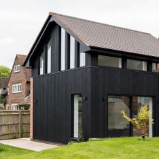 rebuilding an extension exterior of a property with a large extension covered in black timber cladding