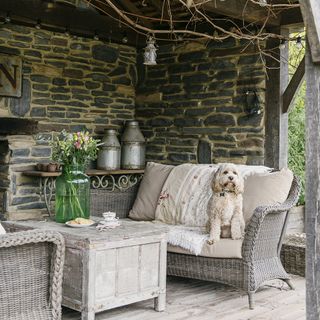 outdoor with stone walls and sofa set with cushion