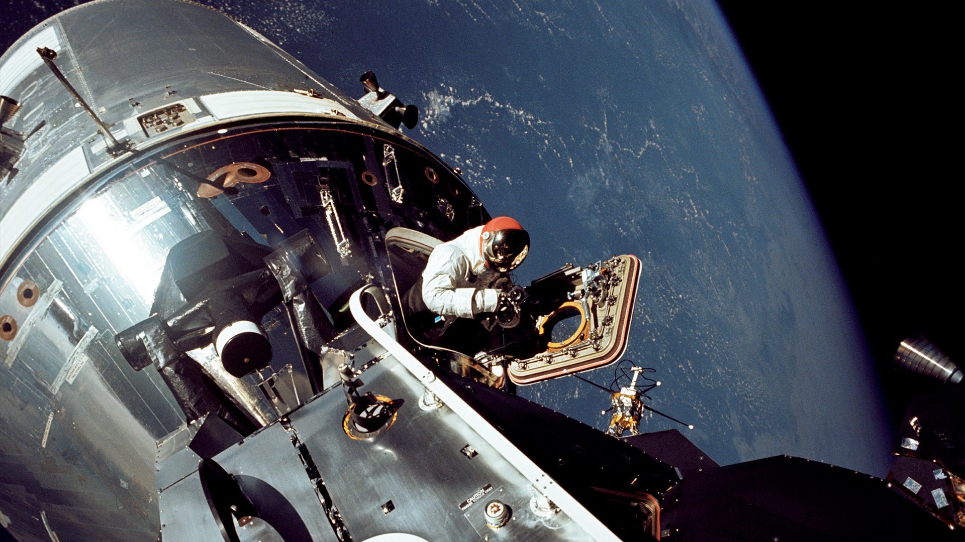 NASA astronaut David Scott performs a stand-up extravehicular activity (SEVA) outside the Apollo 9 command module in Earth orbit in 1969.