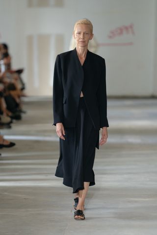 a model wears a rachel comey blazer and skirt with open toe sandals at new york fashion week