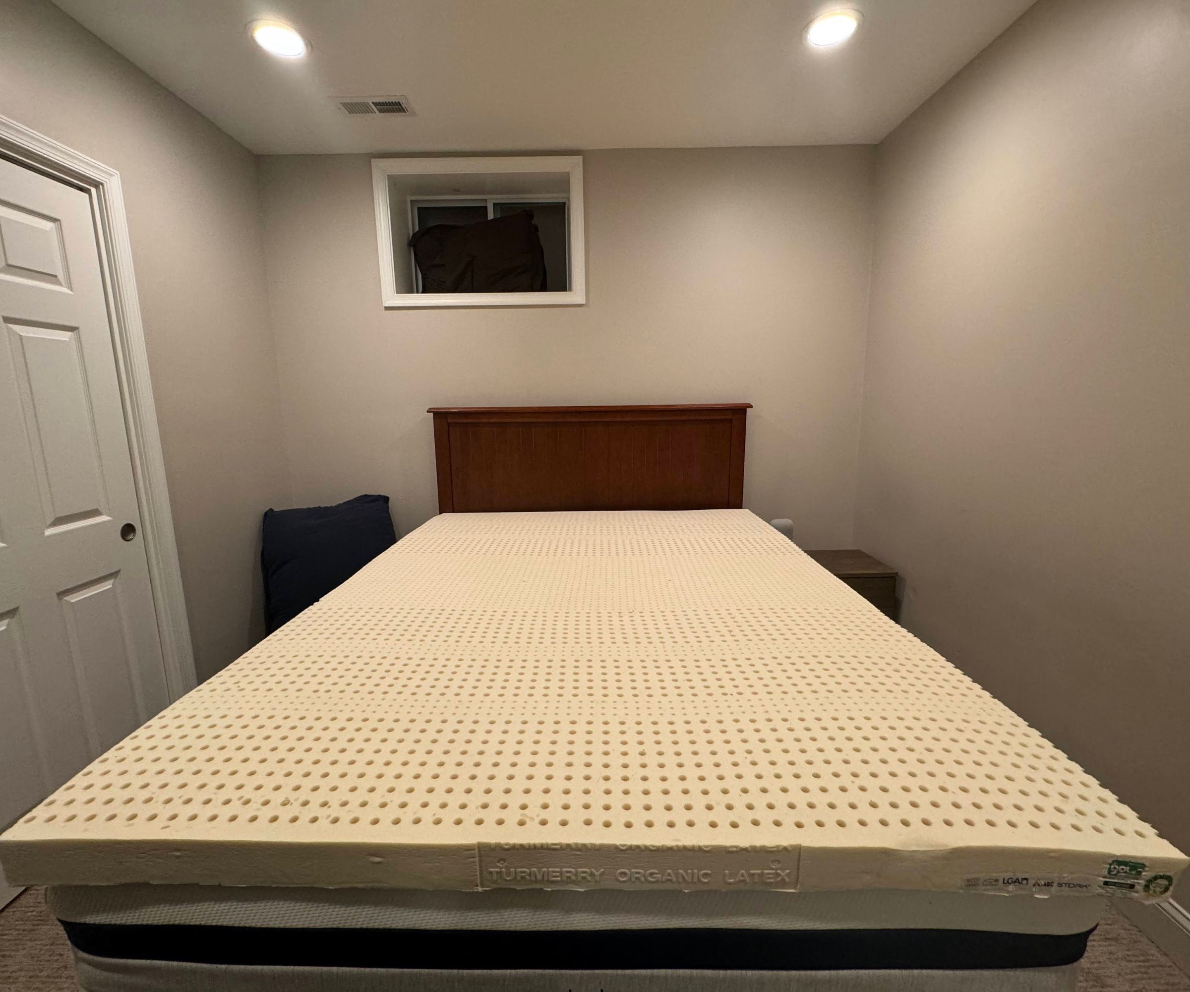 The Turmerry Latex Mattress Topper on a bed.