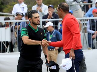 abraham ancer and tiger woods shaking hands