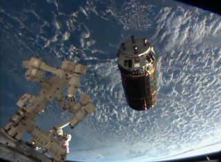 The unmanned Japanese cargo ship HTV-4 (Konoutori 4) hovers near the International Space Station during rendezvous and docking operations on Aug. 9, 2013.