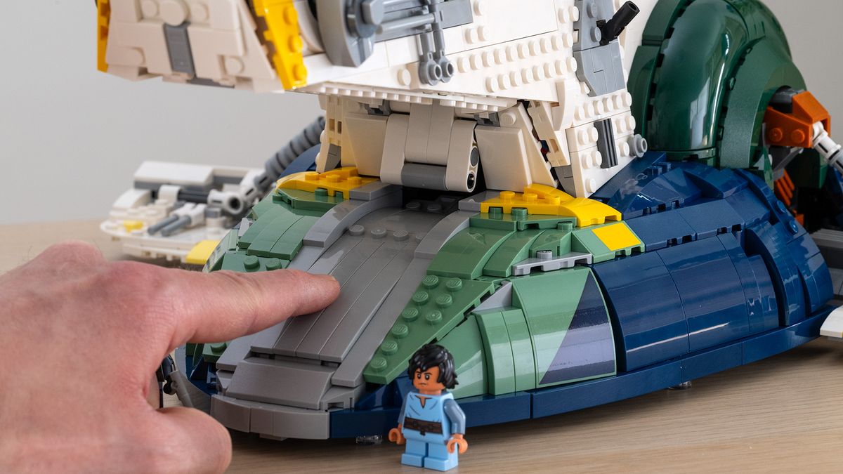 Lego Star Wars UCS Jango Fett&rsquo;s Firespray-Class Starship (75409) hand pressing down on hinged ramp with Boba Fett in the foreground