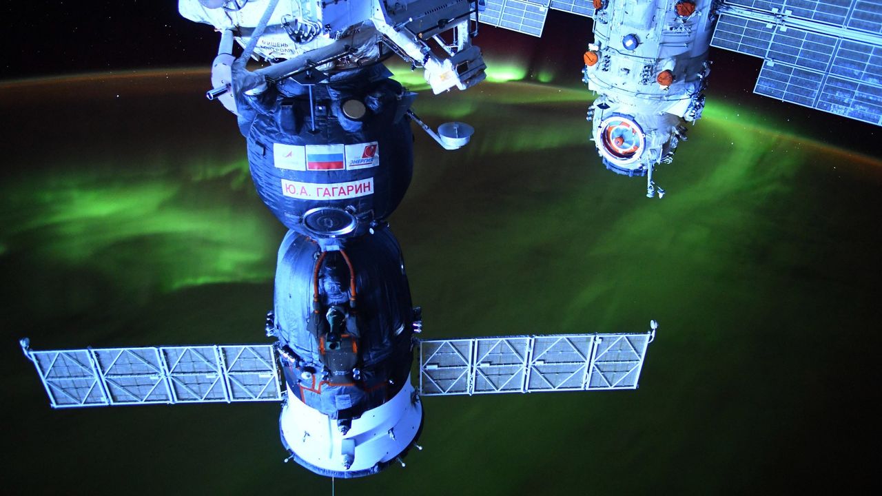 European Space Agency astronaut Thomas Pesquet captured a view of a Russian Soyuz spacecraft and the space station's new Russian Nauka science module against a backdrop of glowing aurora on Aug. 3, 2021.