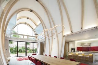 large double height curved ceiling with dining table