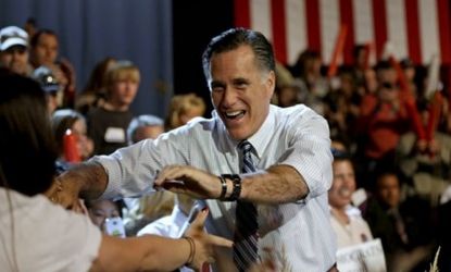 Mitt Romney greets supporters as he takes the stage for a campaign event at the Red Rocks Amphitheatre on Oct. 23 in Golden, Colo.