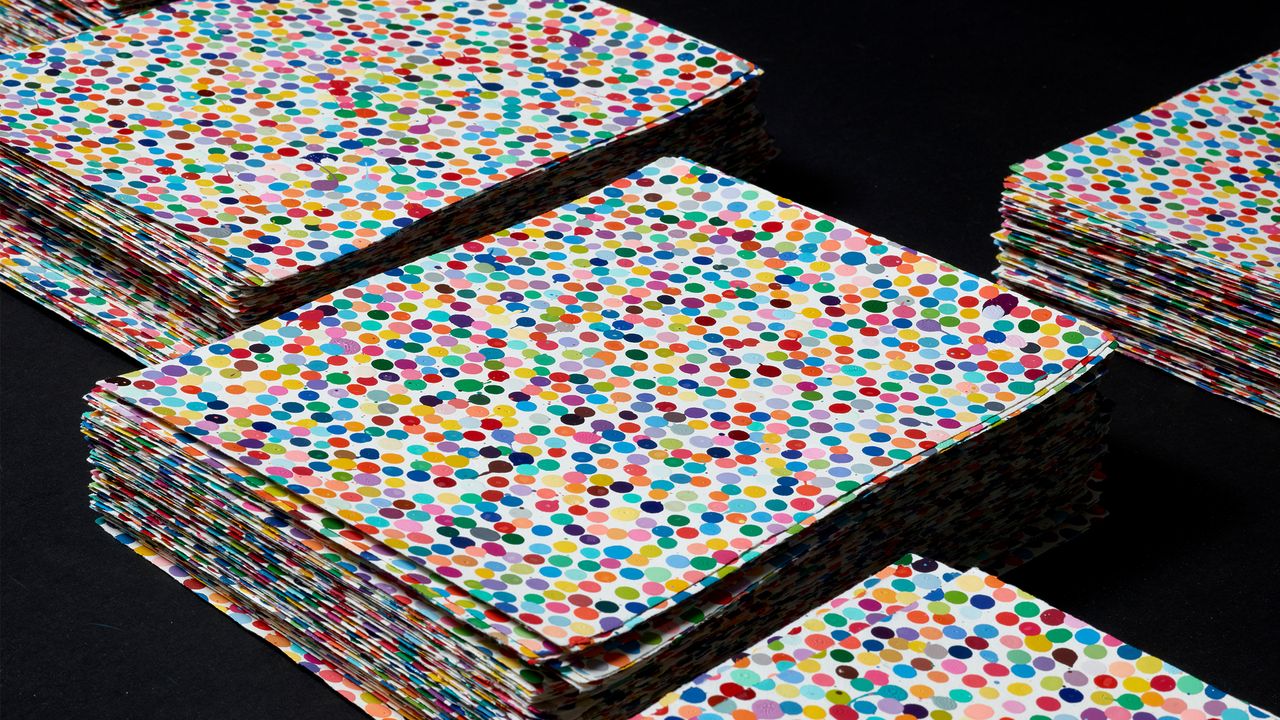 Stacks of artworks, each a piece of paper with lots of dots on