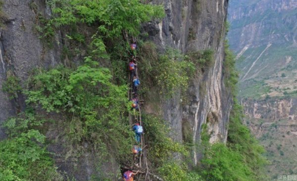 Children make their way down from their village to school.