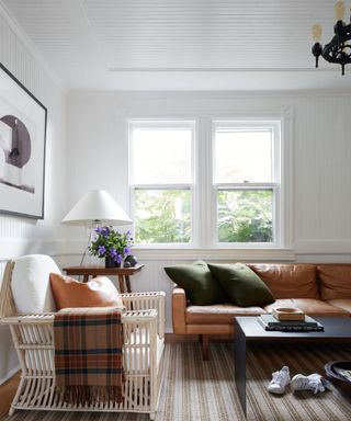 Living room with armchairs and windows in background