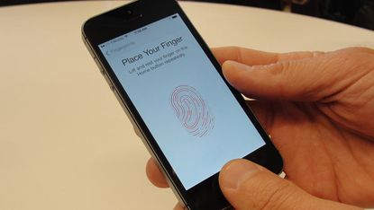 New iPhone 5S handsets let people use their fingerprints to unlock the smartphones at an iPhone event at Apple's headquarters in Silicon Valley on September 10, 2013 in Cupertino, California.