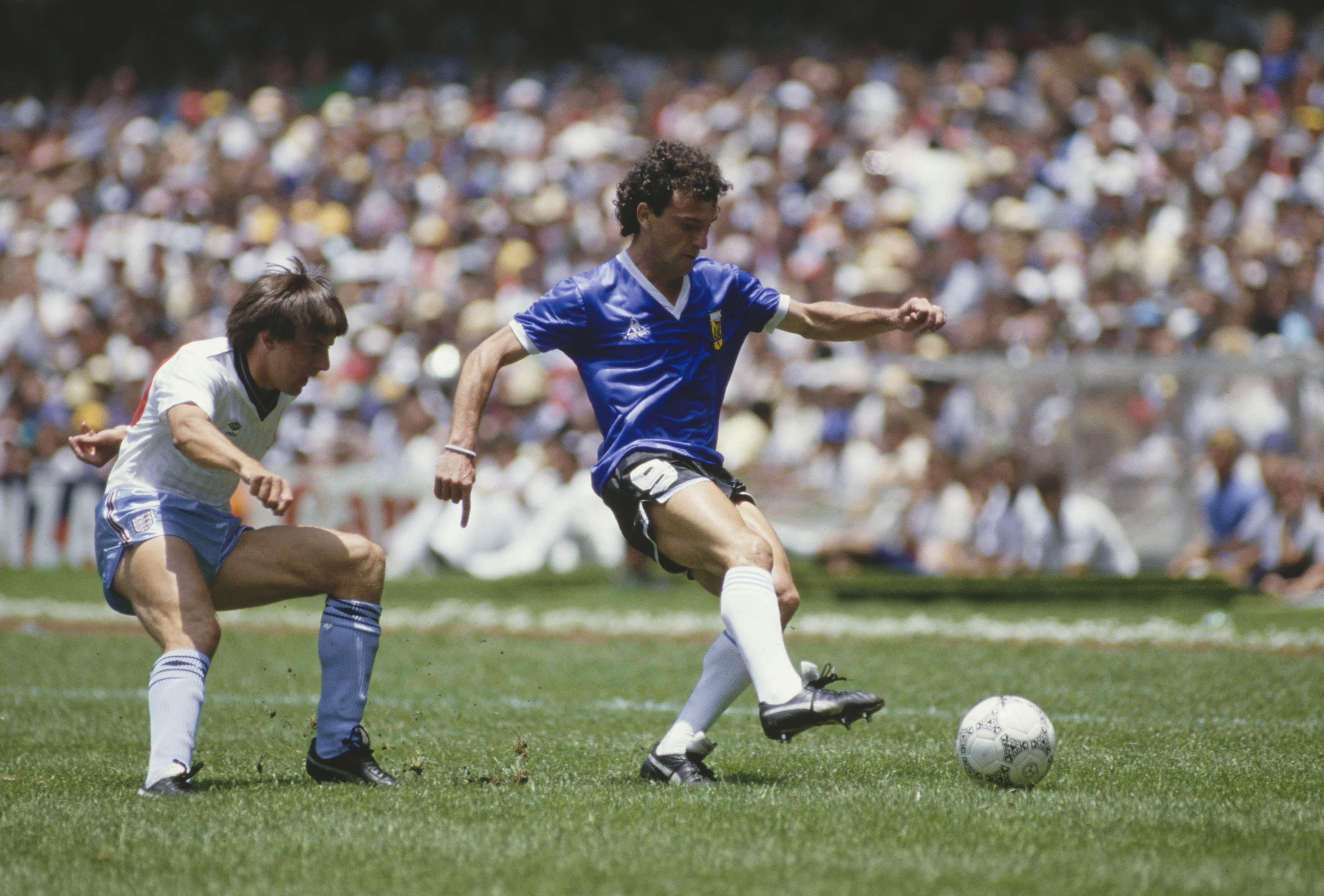 Argentina's Jose Luis Cuciuffo under pressure from England's Peter Beardsley at the 1986 World Cup.