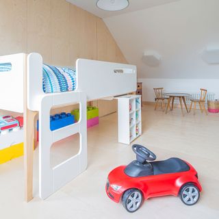 children bedroom with high bed storage blocks and car