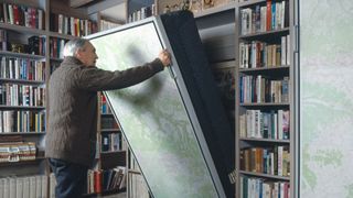 A man unfolding a Murphy bed