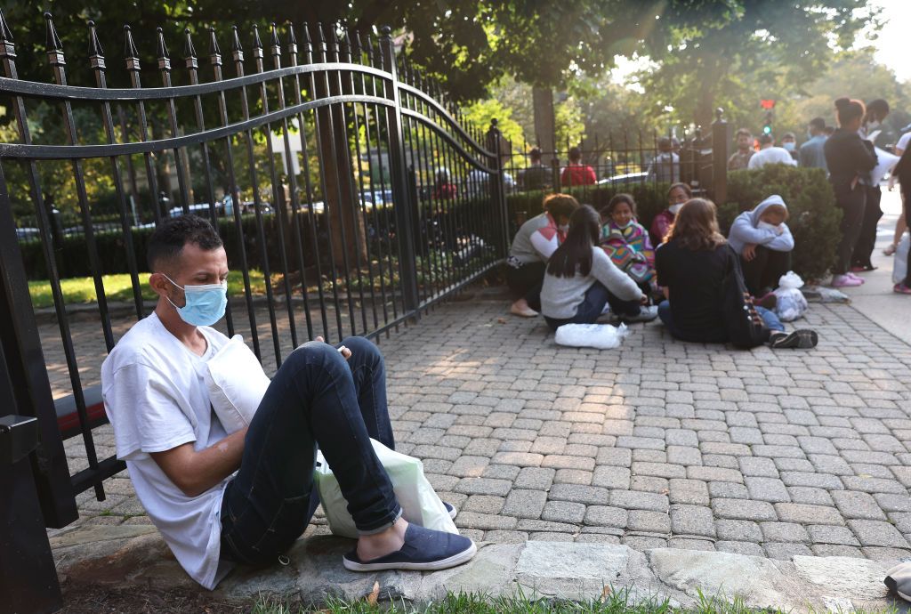 Migrants outside Harris&amp;#039; residence.