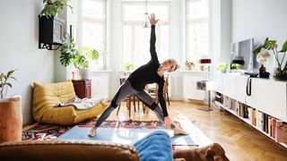 A runner practises yoga in their lounge