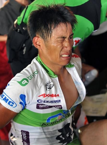 Chun Kai Feng (Action Cycling Team) winced in pain when given treatment by a medical team after crashing 2km from the finish line