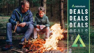 Boy and father by a campfire