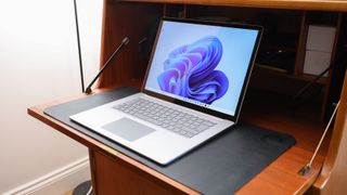 A Microsoft Surface Laptop 5 on a wooden desk, one of the best photo-editing laptops