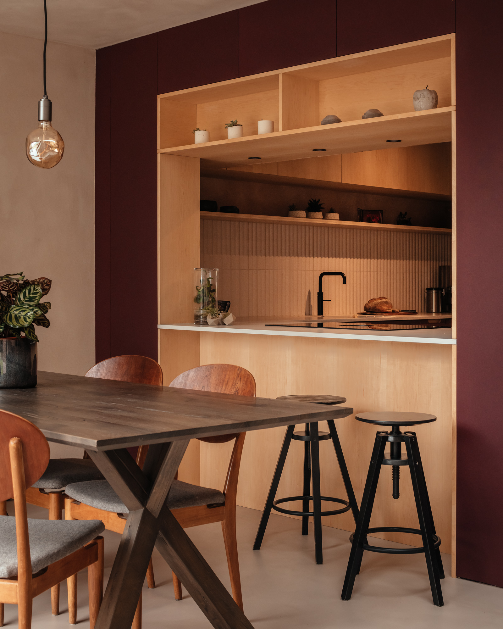 a view through a kitchen hatch in a modern kitchen extension with a dining table