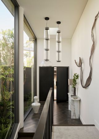 An entryway with a pair of pendant lights