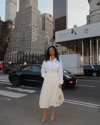 fashion editor Sierra Mayhew wearing a white shirt and cream midi skirt