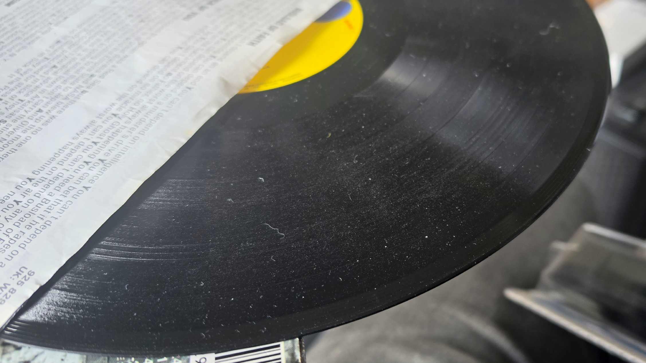 A dusty vinyl, poking out of a record sleeve.
