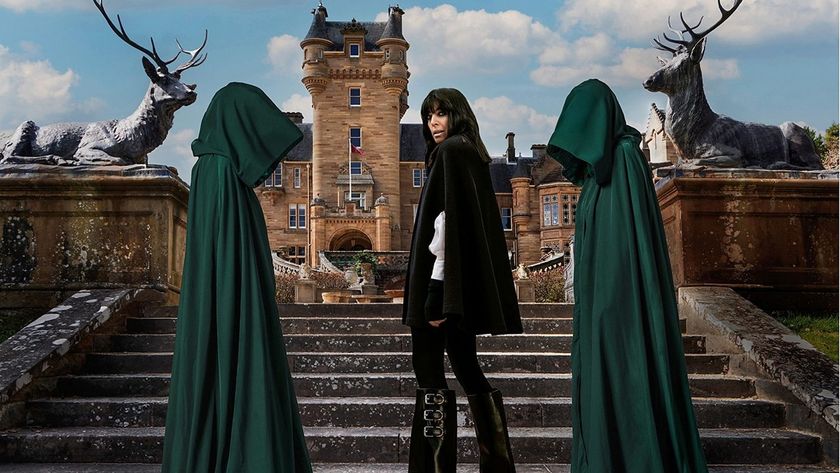 Host Claudia Winkleman looks over her shoulder at the camera on the stairs leading to the stately Ardross Castle, while flanked by two mysterious figures obscured by green cloaks in a promo shot for The Celebrity Traitors.