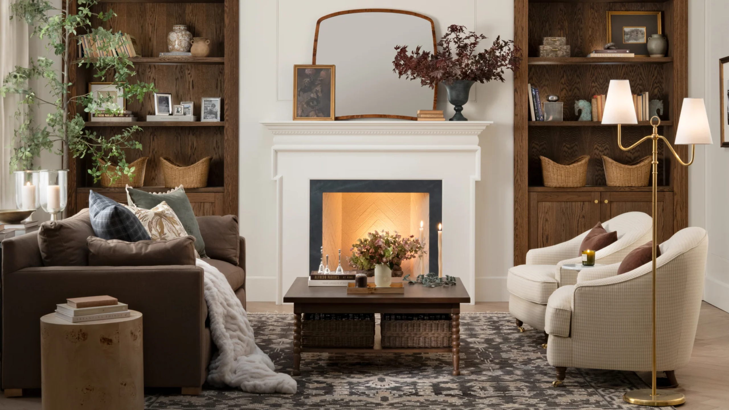 a cozy living room with a large sofa, two accent chairs, and a coffee table