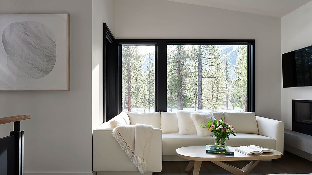 white sectional sofa and coffee table in corner window